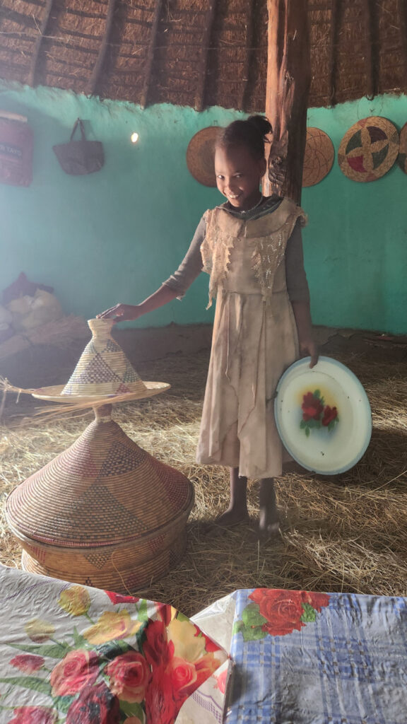 Inside the family hut, this young girl prepared food and drink for us