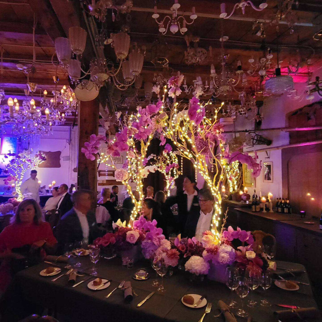 Main course in vintage wine cellar with chandelier-bedecked ceiling and illuminated branches.